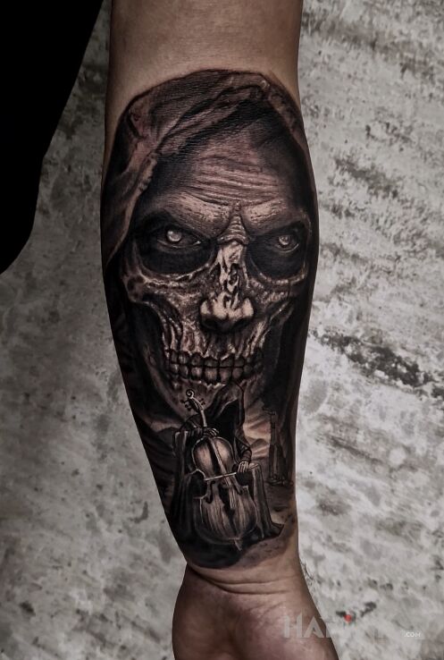 Tattoo Grająca Śmierć in characters motif and realistic style on the forearm