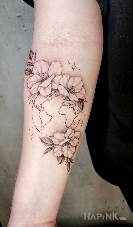 Tattoo Świat w kwiatach in black and gray motif and graphic / illustrative style On the arm