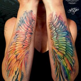 Tattoo Color wing tattoo On the arm motif: wings style: Watercolor