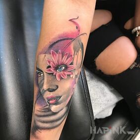 Tattoo The girl with the flower on the upper arm motif: faces style: realistic