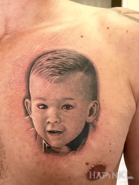 Tattoo Portret dla syna in faces motif and realistic style on the chest