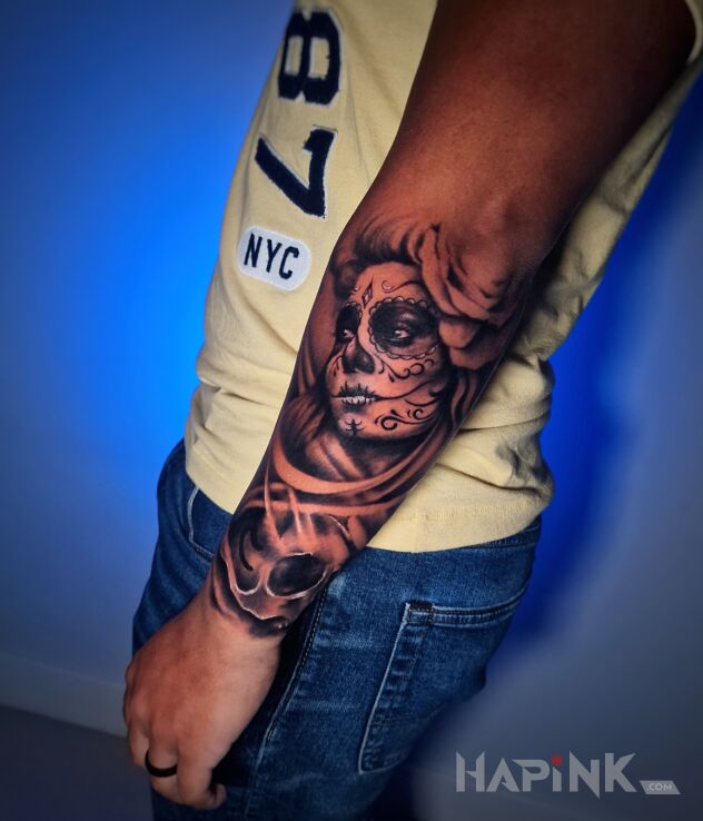 Tattoo Santa muerte na przedramieniu in faces motif and realistic style On the arm