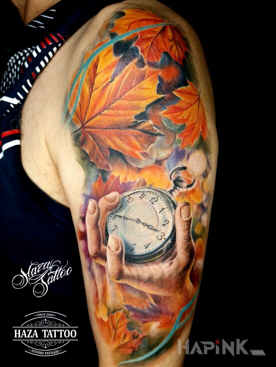 Tattoo Autumn leaves Clock Hand tattoo in colorful motif and realistic style On the arm
