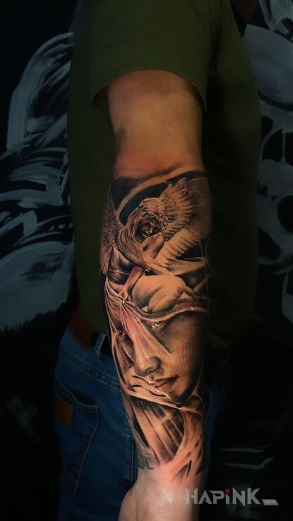 Tattoo Aniołek in angels motif and realistic style on the forearm