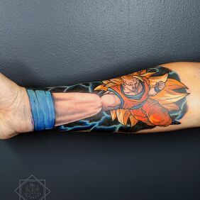 Tattoo Forearm tattoo of Goku's fist from Dragon Ball on the forearm motif: colorful style: cartoon / comic book