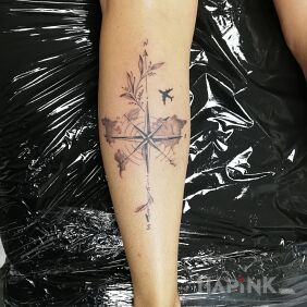 Tattoo Compass Rose on the leg motif: black and gray style: graphic / illustrative