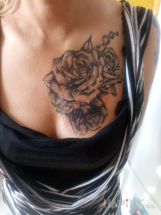 Tattoo Róża in black and gray motif and realistic style on the breast