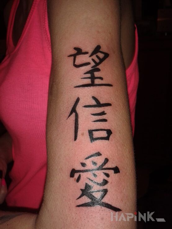 Tattoo Znaki in lettering motif on the upper arm
