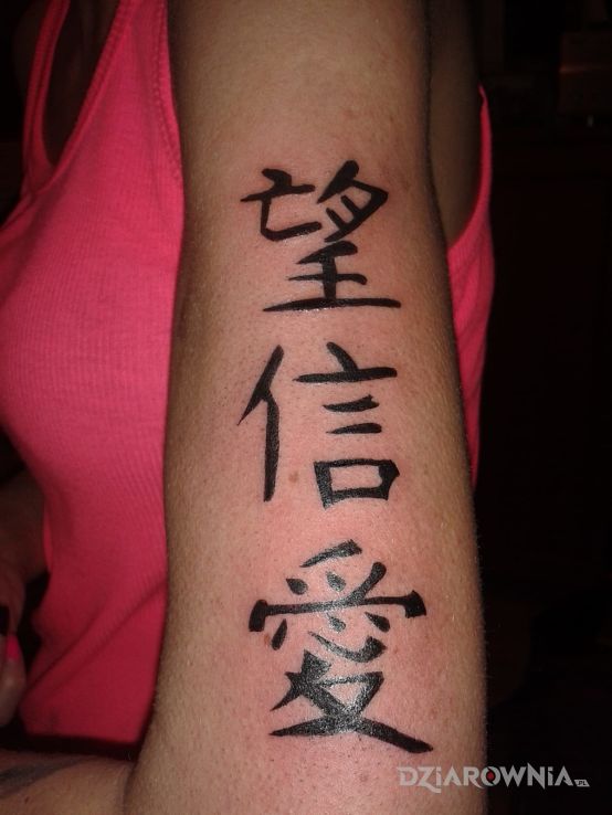 Tatuaż znaki w motywie napisy na ramieniu