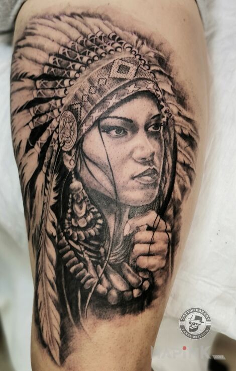 Tattoo Indianka in faces motif and realistic style on the thigh