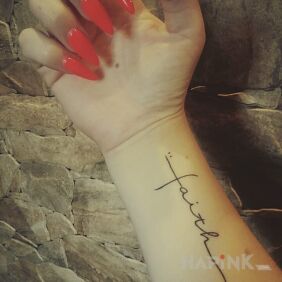 Tattoo Faith on the forearm motif: lettering