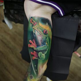 Tattoo Frog on the bicep motif: colorful style: realistic