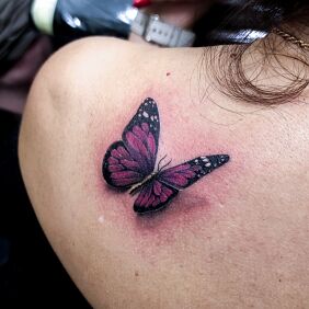 Tattoo Colorful 3D butterfly female tattoo on the back motif: colorful style: realistic