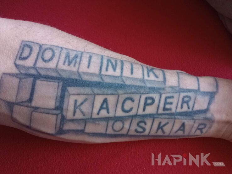 Tattoo Imiona dzieci in black and gray motif On the arm