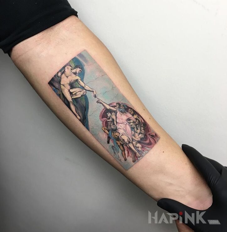 Tattoo Stworzenie człowieka in religious motif and realistic style on the forearm