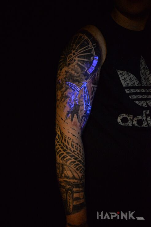 Tattoo UV tatuaż in sleeves motif and realistic style on the forearm