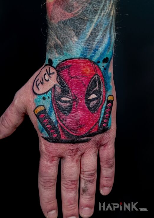 Tattoo Tatuaż męski na dłoni Deadpool in funny motif and cartoon / comic book style On the arm