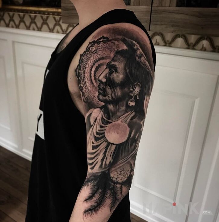 Tattoo Indianin in characters motif and realistic style on the upper arm