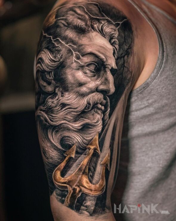 Tattoo Posejdon in faces motif on the upper arm
