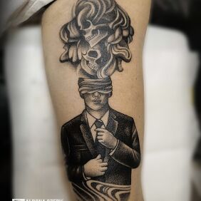 Tattoo Abstract Man on the bicep motif: black and gray style: surrealistic