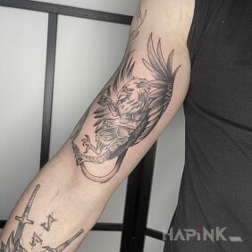 Tattoo Witcher Griffin on the bicep motif: fantasy style: graphic / illustrative