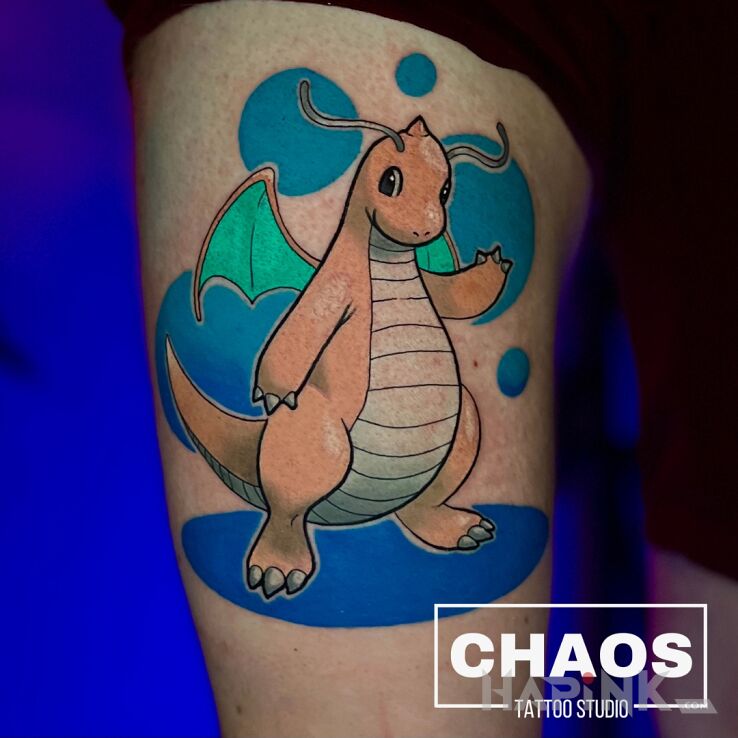 Tattoo Dragonite Pokemon in colorful motif and cartoon / comic book style on the thigh