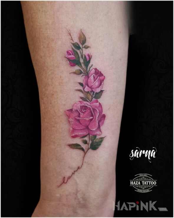 Tattoo Colorful rose tattoo in flowers motif and realistic style On the arm