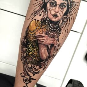 Tattoo Gold on the calf motif: colorful style: graphic / illustrative