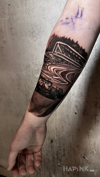 Tattoo Fomuła 1 in motorization motif and realistic style on the forearm