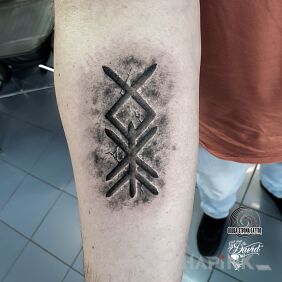 Tattoo Runic amulet On the arm motif: black and gray style: Celtic / Nordic