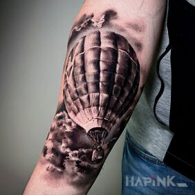 Tattoo Soaring balloon On the arm motif: black and gray style: realistic