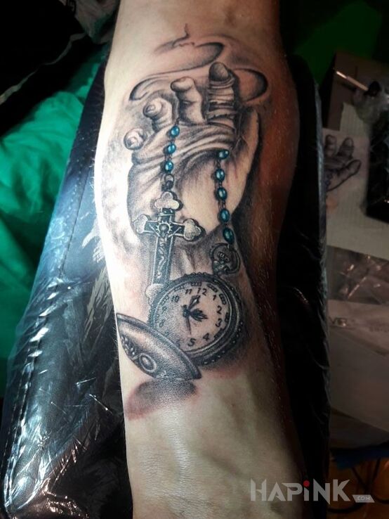 Tattoo Dłoń in religious motif on the forearm