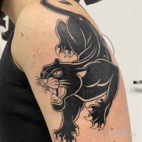 Tattoo Oldschool panther On the arm motif: black and gray style: oldschool