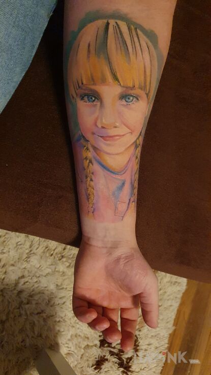 Tattoo Portret dziewczynki blondynki in faces motif and realistic style on the forearm
