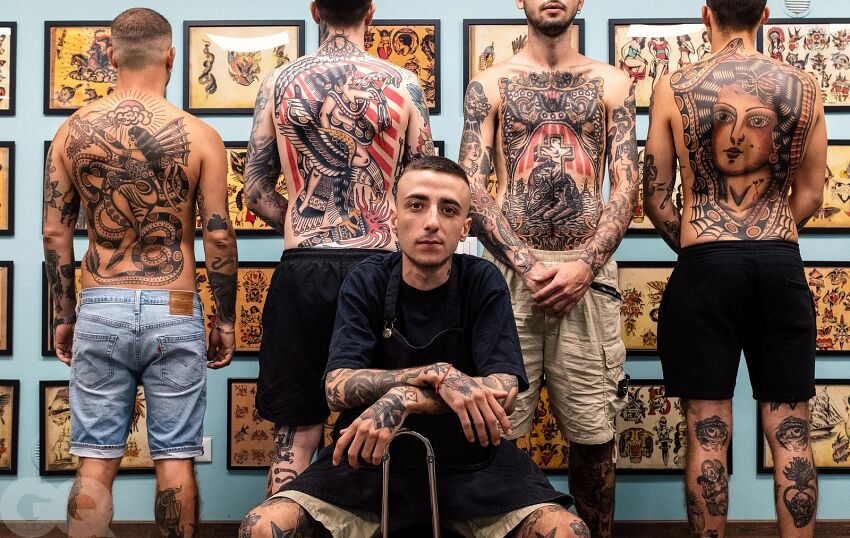 tatuażysta i czterech klientów tradycyjnymi tatuażami