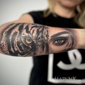 Tattoo Eye of the tiger and woman on the forearm motif: faces style: realistic