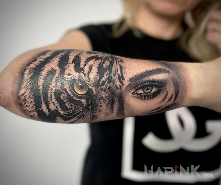 Tattoo Oko tygrysa i kobiety in animals motif and realistic style on the forearm