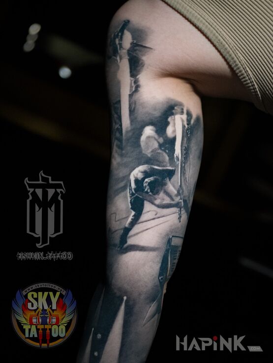 Tattoo Let's make some noise in black and gray motif and realistic style on the bicep