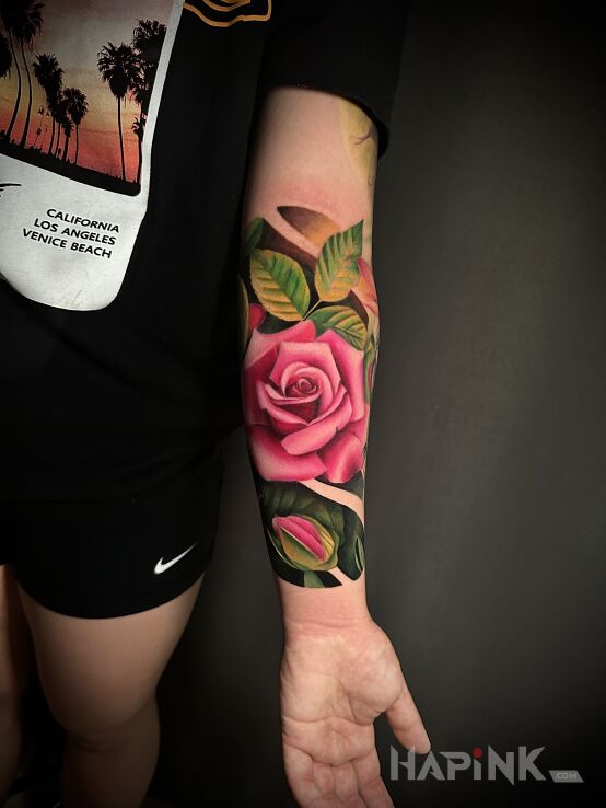 Tattoo Tatuaż róże in colorful motif and realistic style On the arm