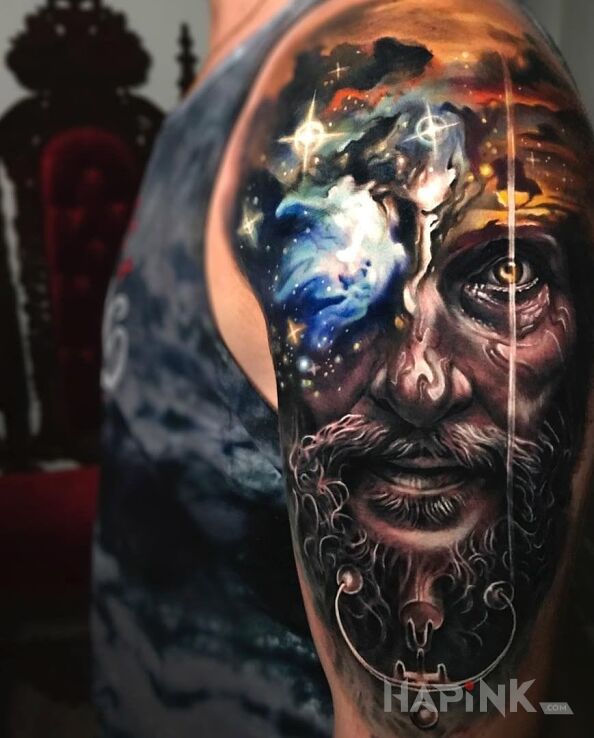 Tattoo Dziadyga in cosmos motif and realistic style on the upper arm