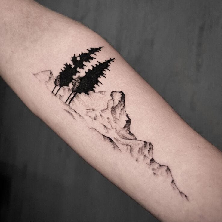 Tattoo Mountain landscape in nature motif and graphic / illustrative style on the forearm