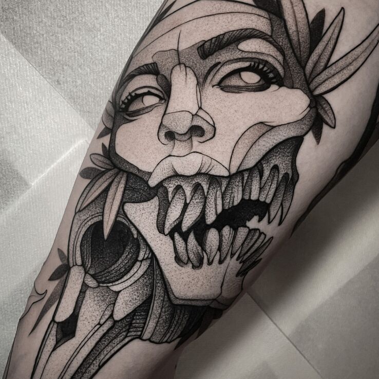 Tattoo Amber Tattoo in faces motif and graphic / illustrative style on the leg