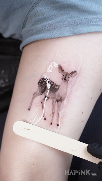 Tattoo Microrealism in black and gray motif and realistic style on the upper arm
