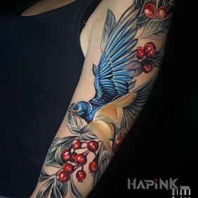 Tattoo Swallow rowan twigs on the upper arm motif: floral style: realistic