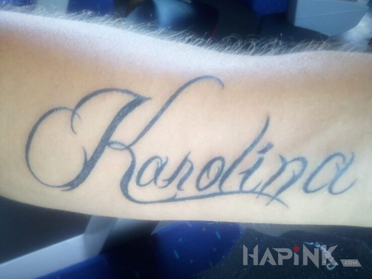 Tattoo Moja cura in lettering motif on the forearm