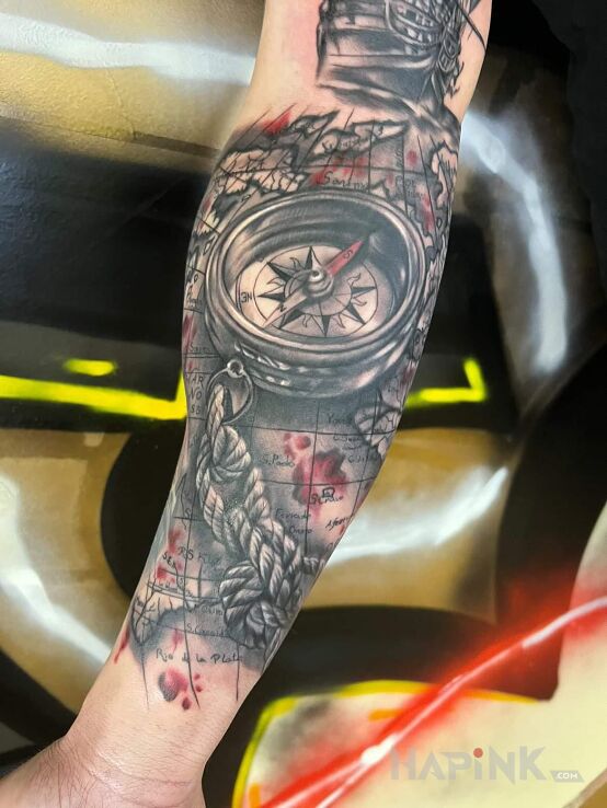 Tattoo Kompas z mapą in black and gray motif and realistic style on the forearm