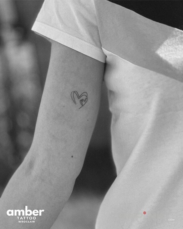 Tattoo Mini serce in Love motif and minimalistic style On the arm