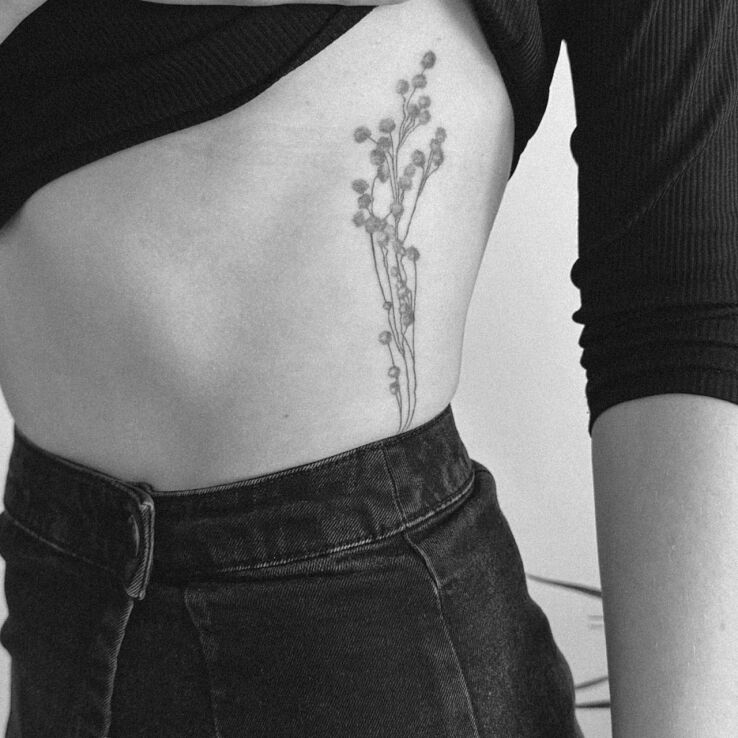 Tattoo Flowers from the field in floral motif and graphic / illustrative style on the ribs