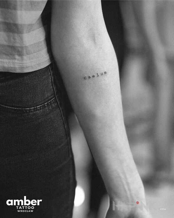 Tattoo Caelus in małe motif and calligraphy style On the arm