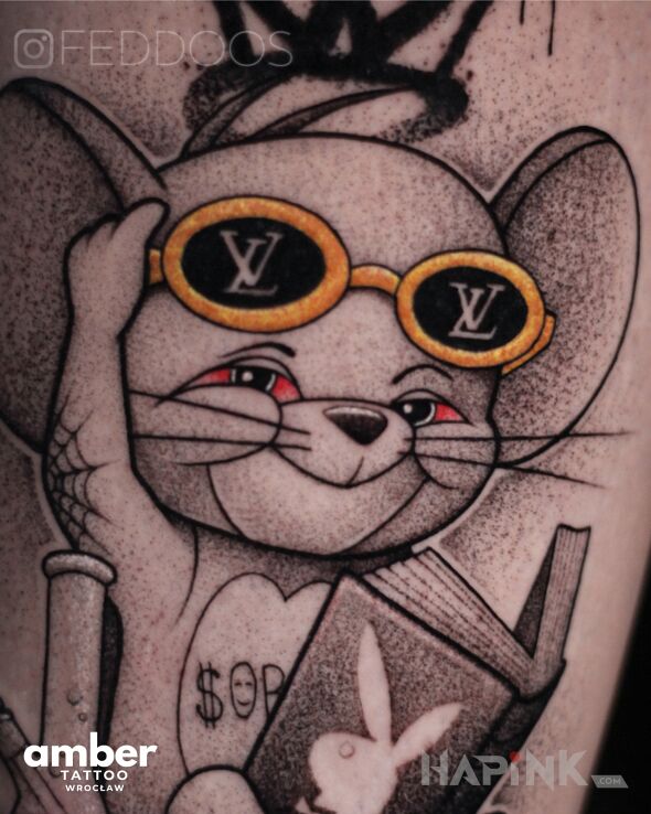 Tattoo Zjarany Jerry in black and gray motif and graphic / illustrative style on the upper arm
